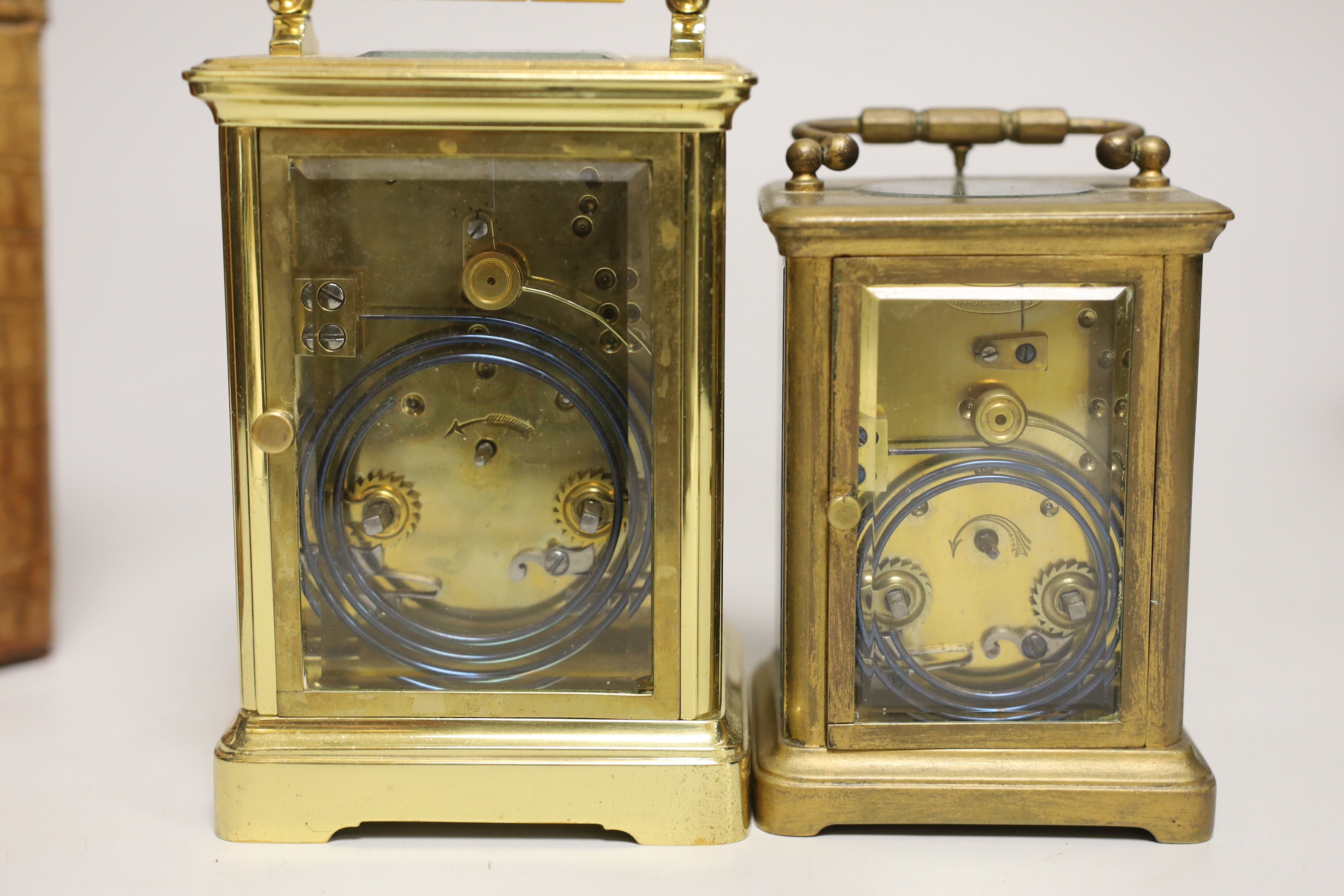 Two cased brass carriage cased clocks, one a repeating carriage clock, tallest 15cm high